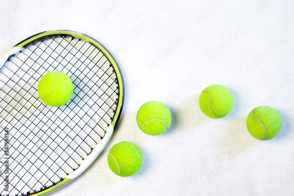 tennis balls and a racket on white background, with copy space