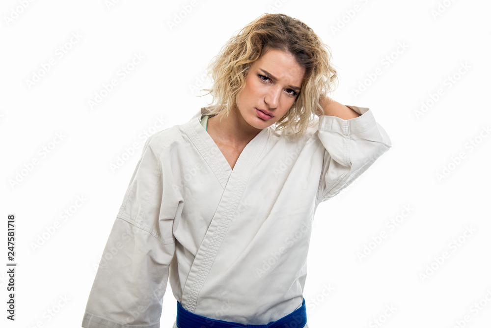 Portrait of female wearing martial arts uniform holding head like hurting Portrait of female wearing martial arts uniform holding head like hurting