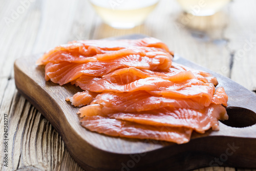 Smoked salmon on wooden board, sliced