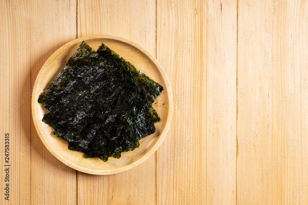 Crispy dried seaweed on wooden dish Crispy dried seaweed on wooden dish