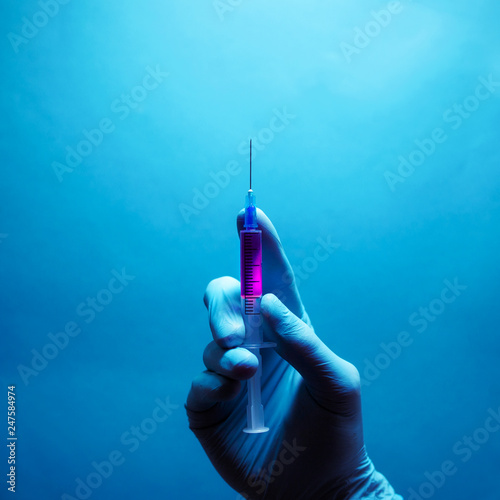 Beauty injection concept. Syringe with violet liquid for hypodermic injection. photo