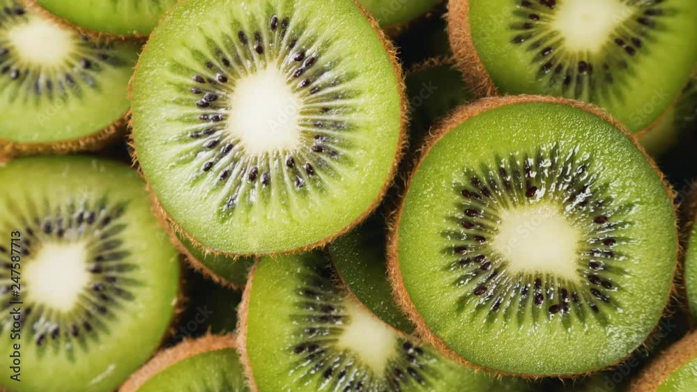 Heap of fresh sliced kiwi fruits rotating. Closeup macro shot. Fresh berry series. 4k. Heap of fresh sliced kiwi fruits rotating. Closeup macro shot. Fresh berry series. 4k.