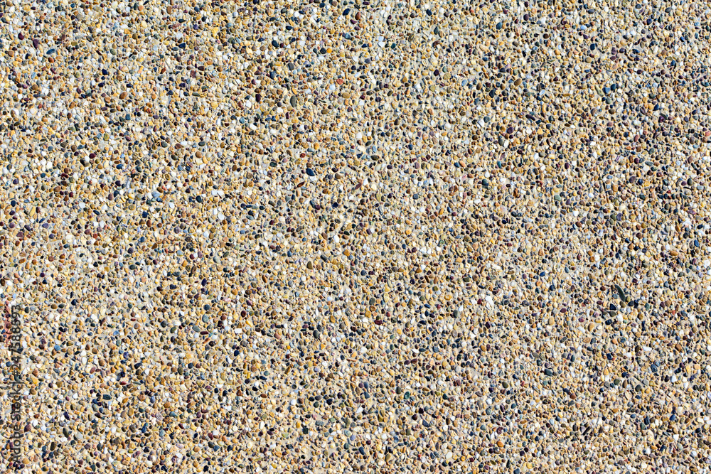 Backgrounds of sand stone wall. Small pebbles mixed with sand texted background. Backgrounds of sand stone wall. Small pebbles mixed with sand texted background.