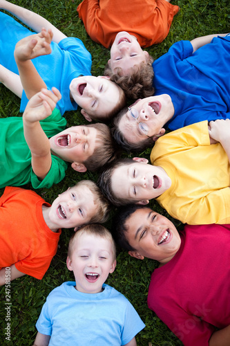 Group of Boys Laughing in Grass Outside
