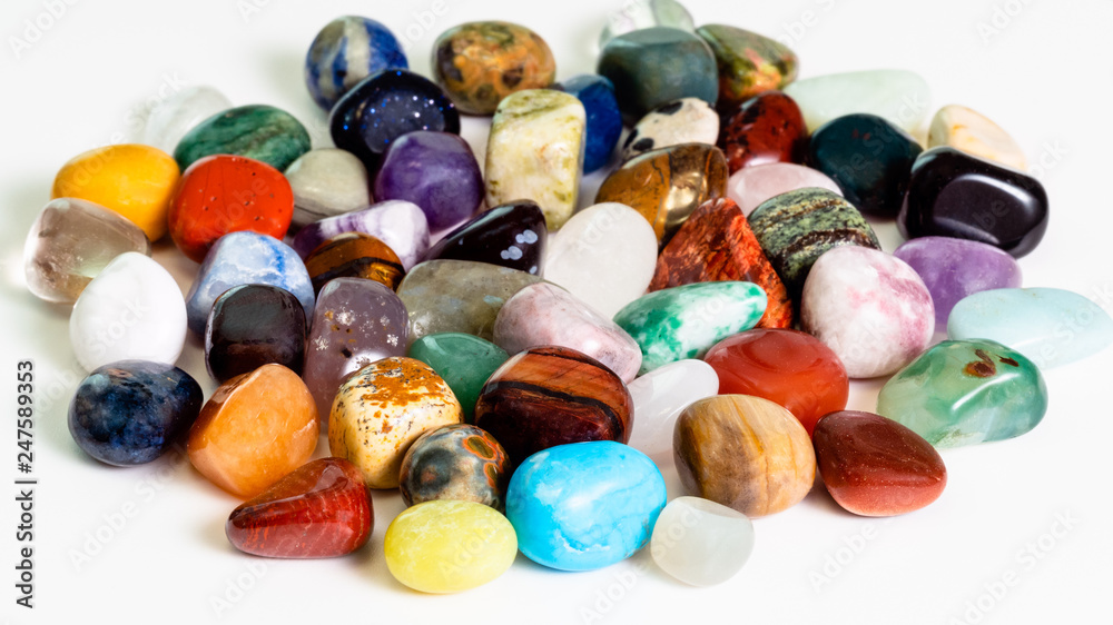 handful of various gem stones on white handful of various gem stones on white