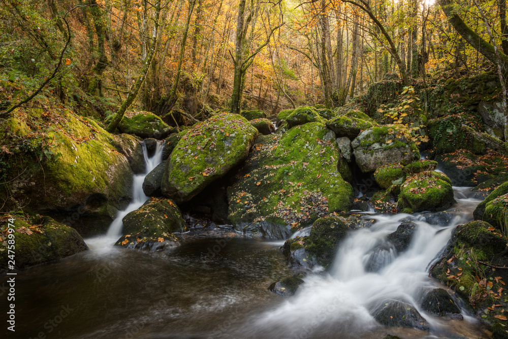 Waterfalls between granite rocks covered with moss Waterfalls between granite rocks covered with moss