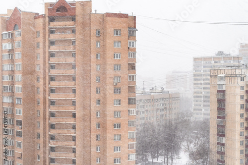 high-rise residential buildings in snowfall photo