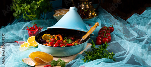 Tasty spicy beef with various vegetables cooked in tagine photo