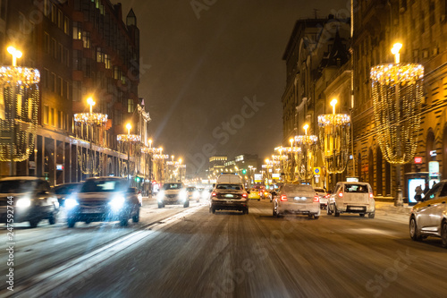 cars on Tverskaya street at snow winter night