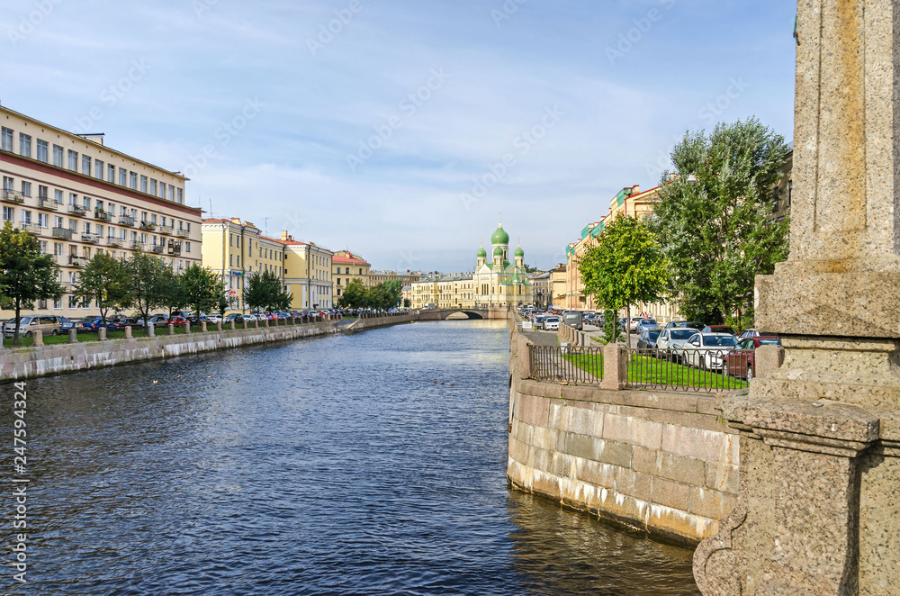 Griboyedov Canal embankment with the  Mogilyovsky Bridge and the St.Isidore Church in St.Petersburg, Russia