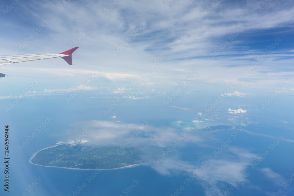 Fototapeta premium Air plane wing over the land. Can use for airline transportation background.