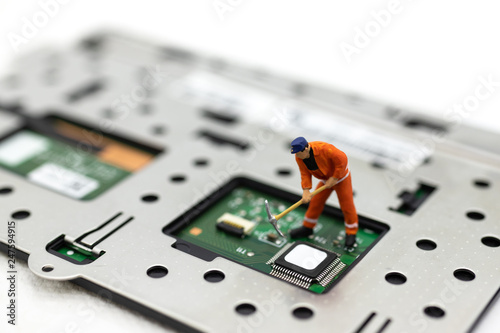 Miniature people: Worker repairing circuit board ,electronics repair. Use image for support and maintenance business. photo