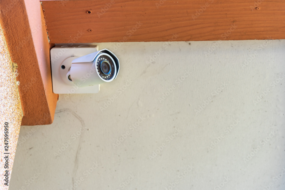 Security camera CCTY at house's ceiling for private building property protection.