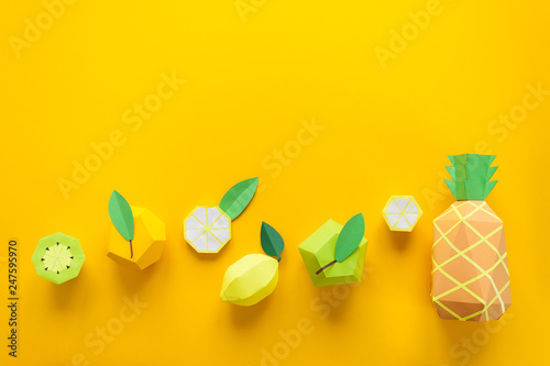 Fruit made of paper. Yellow background. There's room for writing. Tropics. Flat lay. Pineapple, Apple, lemon, banana and kiwi.