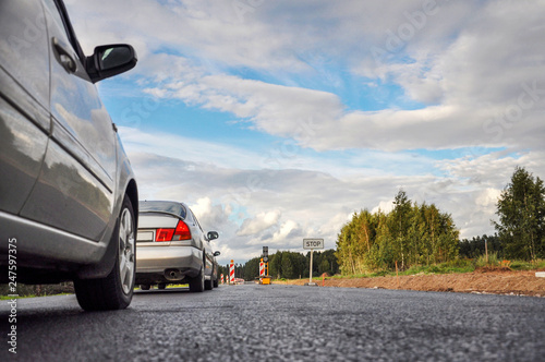 A row of cars at the road repair semaphore, selective focus - image