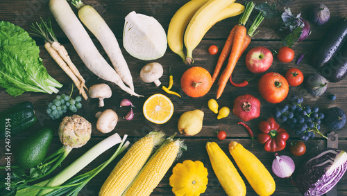 Fototapeta Naklejka Na Ścianę i Meble -  White, yellow, green, orange, red, purple fruits and vegetables on wooden background.  Healthy food. Multicolored raw food.