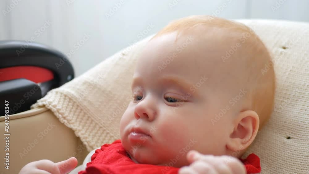 Mother gives baby food from a spoon Mother gives baby food from a spoon