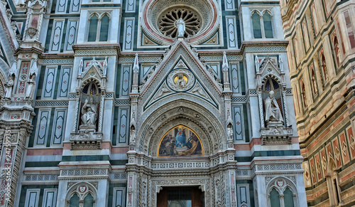 Duomo Florence Cathedral is the third largest church in the world. Italian Renaissance. Architectural details of awesome marble facade with sculptures  painting  rosettes. Italy  Florence