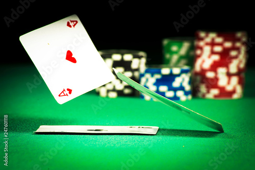 The concept of gambling, scattered cards on green dresses on a background of chips