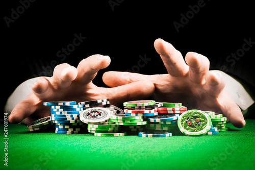 Gambling concept, stack of chips on the background of striped hands