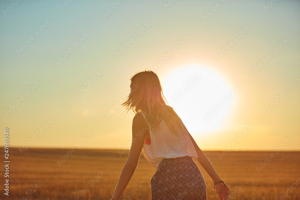 Cute young woman jumping in a wheat field. Cute young woman jumping in a wheat field.