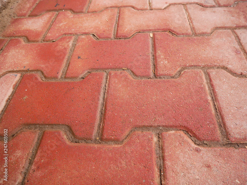 Red dirty sidewalk close up shot at a residentual house, image for background.