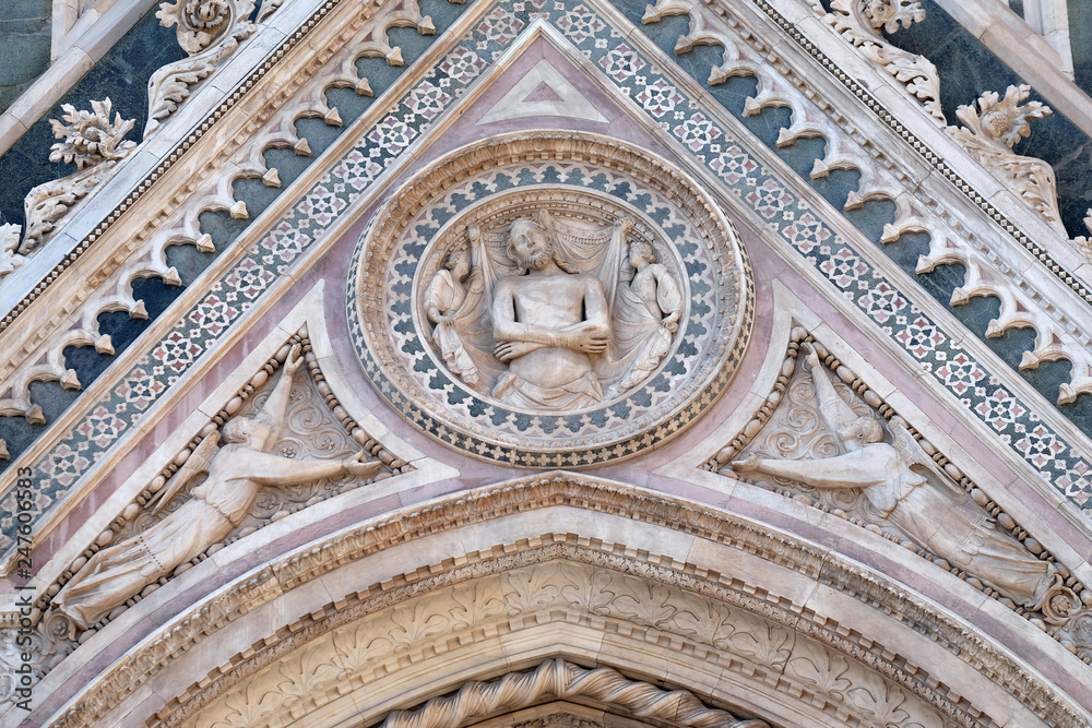 Wrapping Christ in his shroud, Portal of Cattedrale di Santa Maria del Fiore (Cathedral of Saint Mary of the Flower), Florence, Italy Wrapping Christ in his shroud, Portal of Cattedrale di Santa Maria del Fiore (Cathedral of Saint Mary of the Flower), Florence, Italy