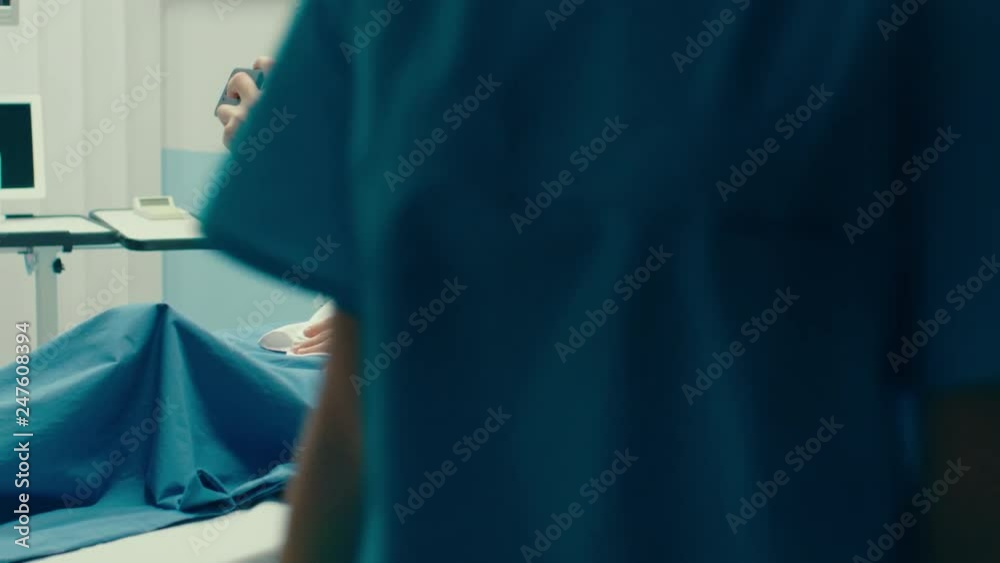 Father Takes Selfie of Him with His Wife Holding Newborn Baby while Lying on the Hospital Bed. Happy Young and Smiling Family. Father Takes Selfie of Him with His Wife Holding Newborn Baby while Lying on the Hospital Bed. Happy Young and Smiling Family.