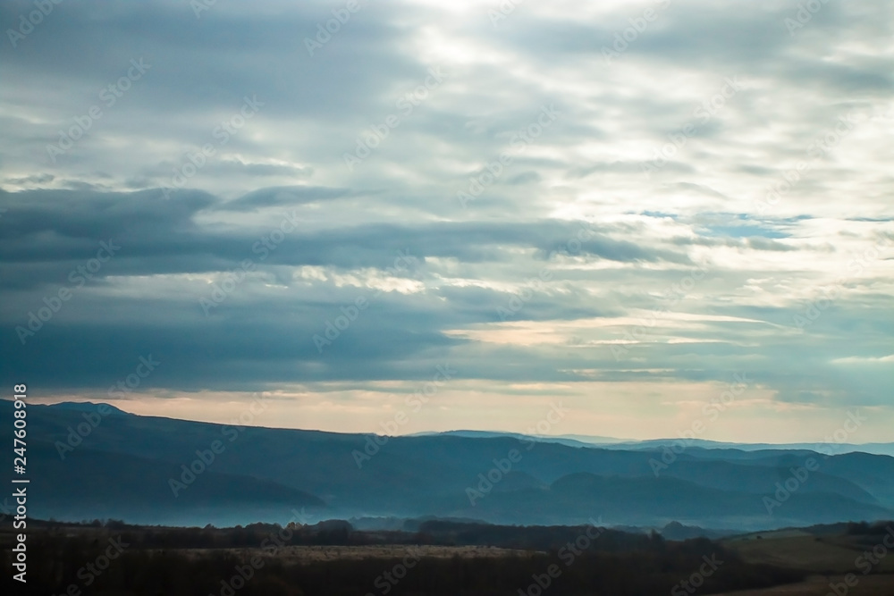 Clouds over misty mountains