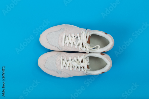 Overhead Shot Of White Sneakers On colored Background