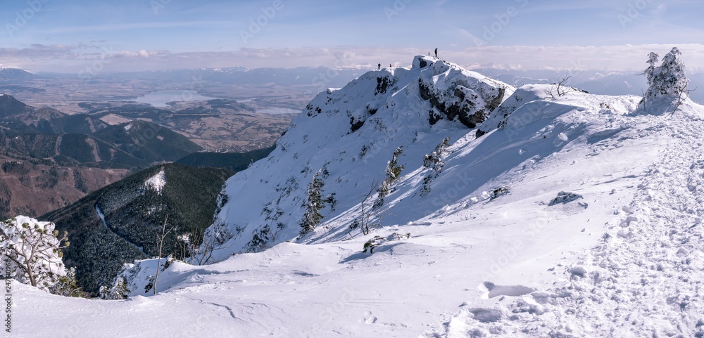 Mountain panorama with mountaineers , in winter