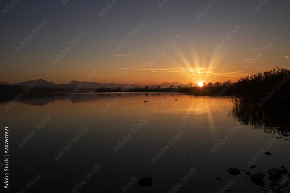 Sunset scene over lake water surface