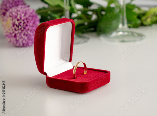 Wedding ring red box surrounded by rose petals. An offer of marriage © zuki-uki