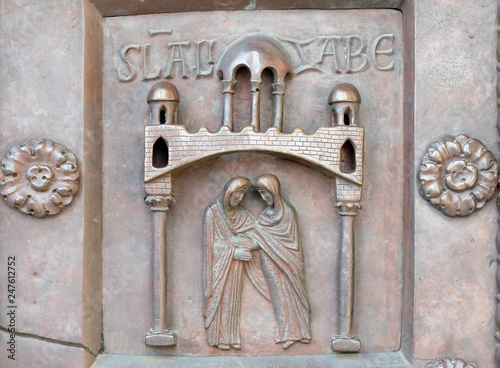 Visitation of the Virgin Mary on the San Ranieri gate of the Cathedral St. Mary of the Assumption in Pisa, Italy  photo