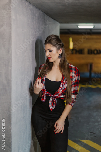 Natural light indoor portrait of young pretty girl with long dark brown hair  natural makeup and red lips. Stylish woman looking at you.