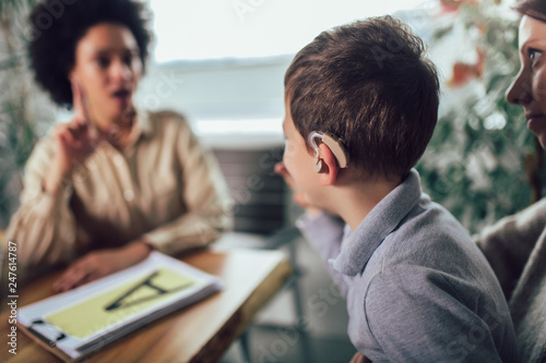 Smiling deaf boy learning sign language