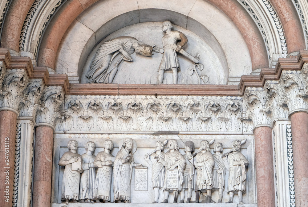 The right portal of the Cathedral of St Martin in Lucca. Lunette dedicated to the life of Saint Regulus, Lucca, Italy.