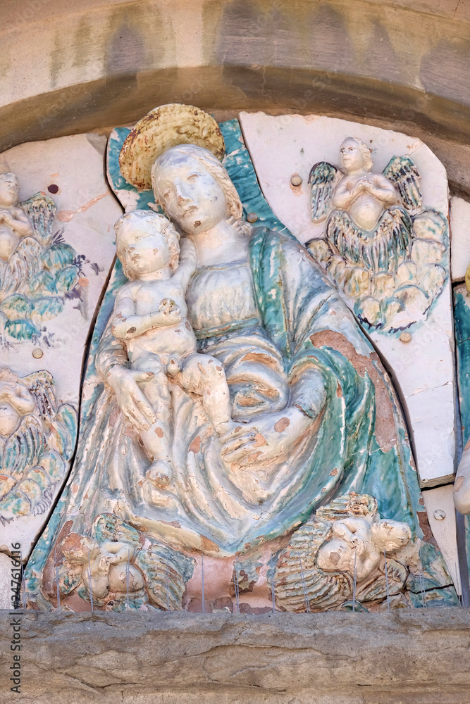 Virgin Mary with baby Jesus on the portal of the Saint Joseph church in Lucca, Italy