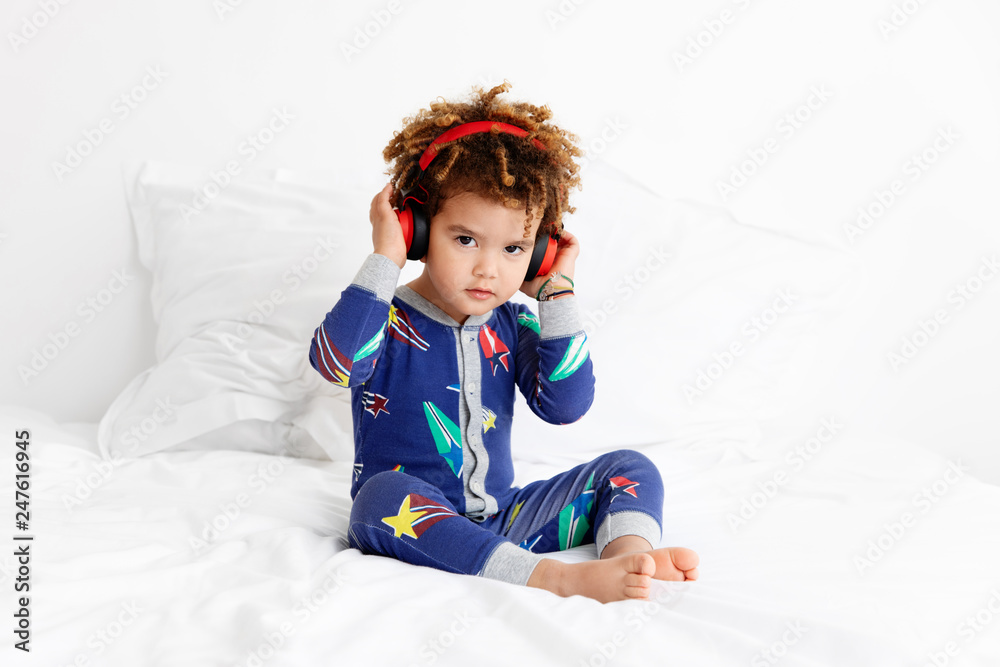 Young boy with afro hair wears headphones Young boy with afro hair wears headphones