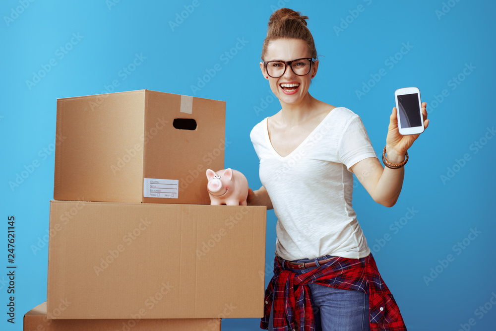 woman showing mobile phone blank screen near cardboard box with woman showing mobile phone blank screen near cardboard box with