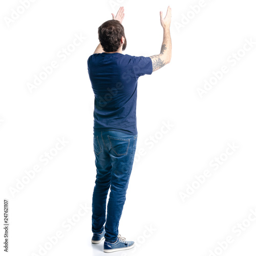 A man in jeans showing on a white background. Isolation, back view photo