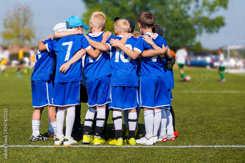 Kids Sport Team Gathering. Children Play Sports. Boys in Sports Jersey Uniforms Having Shout Team. Coach Giving Young Soccer Team Instructions. Youth Sports For Children. Young Boys Soccer Sportswear