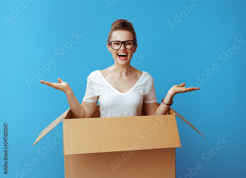 woman presenting something on empty palm pops out of a cardboard