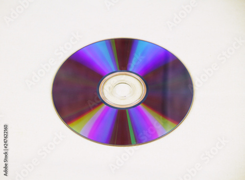 CD or DVD with beautiful colorful reflections laid on white cloth