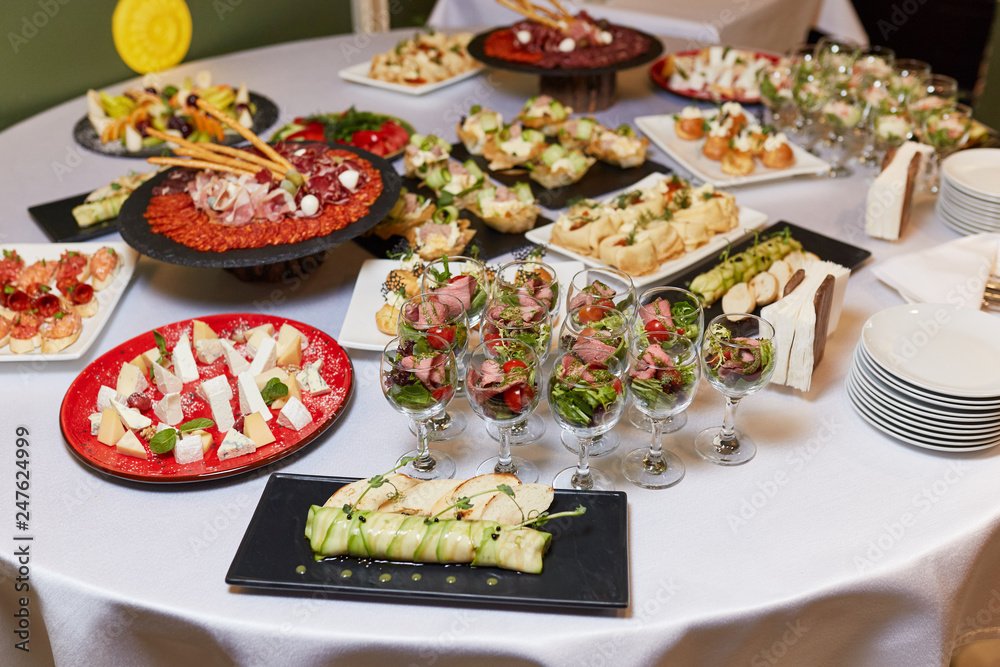 dishes on the table, salads in glasses, snacks, reception