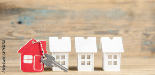 Symbol of the house with silver key on vintage wooden background