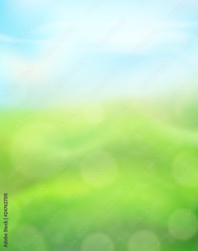 Green nature vertical background on a blurred of grass and sky and