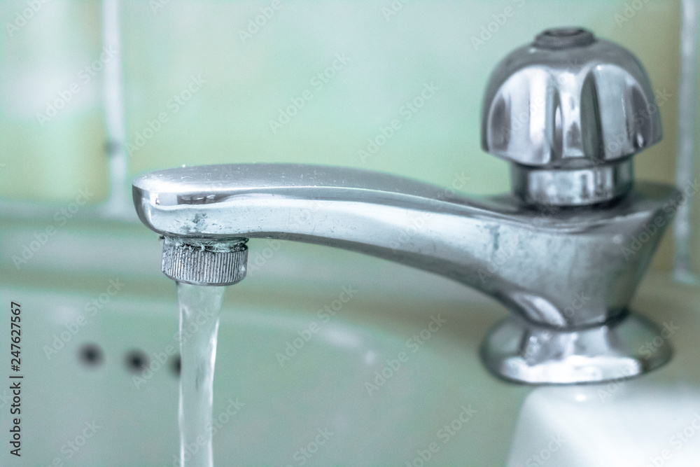 detail of a ceramic sink with old chrome tap, with selective focus. detail of a ceramic sink with old chrome tap, with selective focus.