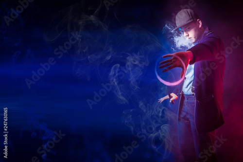 A man blows smoke rings. Th...