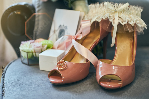 Bride's wedding accessories such as high heel shoes, bouquet, earrings and garter